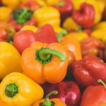 Colorful assortment of fresh, ripe bell peppers in close-up, highlighting food freshness.
